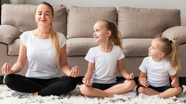 front-view-mother-doing-yoga-with-daughters-home_23-2148492445.jpg